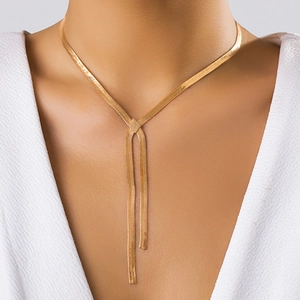 Elegant gold snake bone Y-shaped necklace on model with minimalist flat metal link chain