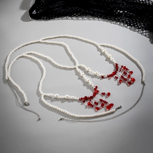 Detail of Gothic pearl waist chain featuring red blood drip tassels and silver lobster clasp