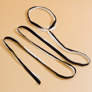 Detailed view of black and white striped elastic leg chain with a silver metal ring connector
