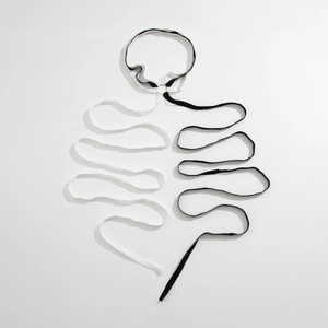 Artistic skeleton-shaped layout of black and white elastic leg chain strap detail