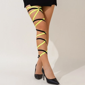 Detail of neon yellow and black elastic leg chain with metal ring for party outfits