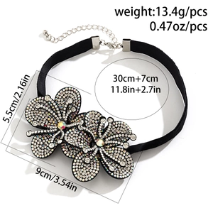 Detail view of black velvet choker with rhinestone flowers and size measurements