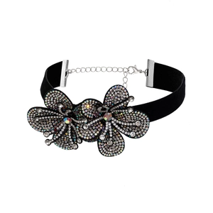 Detail of black velvet choker featuring crystal floral design and adjustable lobster clasp
