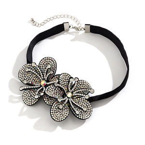 Detail of black velvet choker featuring two rhinestone flowers with central crystals