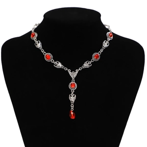 Gothic vampire bat necklace with blood-red rubies and teardrop pendant on black mannequin
