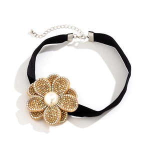 Detail of black velvet choker with rhinestone flower charm and white imitation pearl