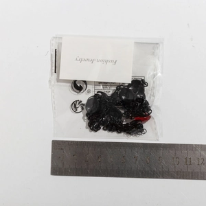Detail view of gothic bat pendant necklace with red bead and measurement scale
