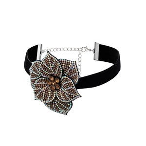 Elegant black velvet choker featuring a sparkling rhinestone flower with silver extension chain