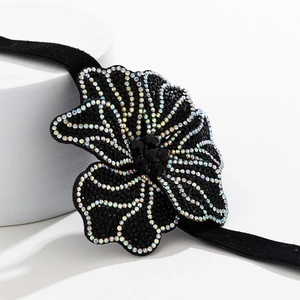 Detailed view of a black velvet flower choker featuring sparkling AB rhinestones and beads