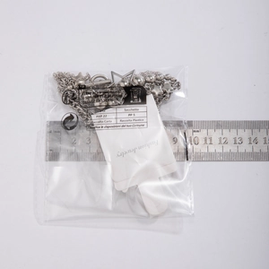 Detailed view of silver star pendant necklace with measurement ruler on white background
