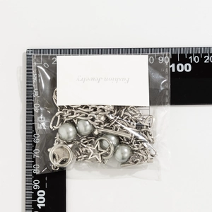 Silver bead chain necklace with star pendant and gray pearls size measurement on scale