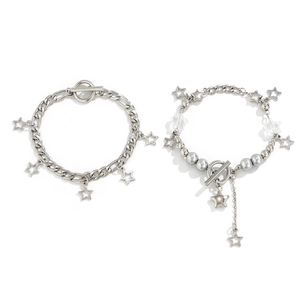 Detail of silver star charm bracelets featuring toggle clasps and metallic beads