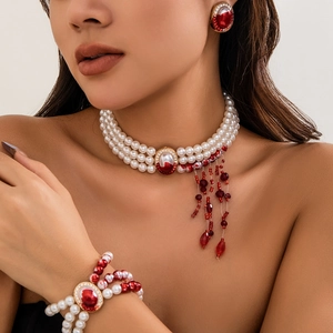 Vintage Gothic three-piece jewelry set with pearl choker, red gemstone, and fringe