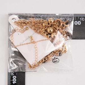 Detailed view of gold star pendant necklace with metallic beads and sizing ruler