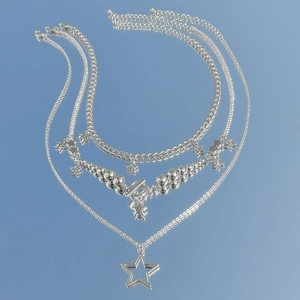 Detailed close-up of multilayer silver star pendant necklaces with polished metal beads