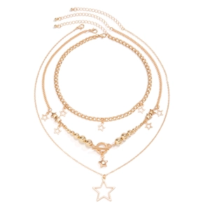 Detail of four-piece gold necklace set with star pendants and polished bead chains