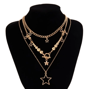Detailed view of triple-layered gold star necklace with cuban chain and bead link texture