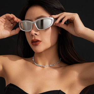 Detail showing metallic liquid lava choker and futuristic silver sunglasses on a model