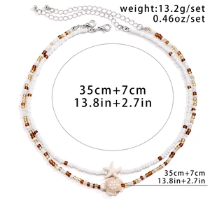 Detail of beaded necklace set with starfish and turtle charms plus adjustable chains