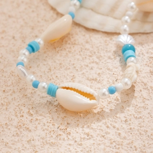 Macro detail of ocean style beaded necklace with starfish shells and turquoise beads