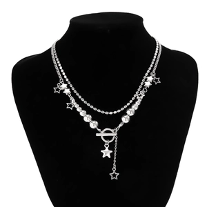 Detail of layered silver beaded chain with star pendants and stylish OT toggle clasp