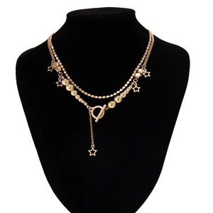 Double-layered gold star pendant necklace with OT toggle clasp on a black bust display
