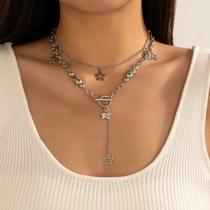 Close-up of double-layer silver star pendant necklace with toggle clasp on a model