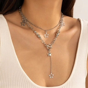 Detail of layered silver star pendant necklace with toggle clasp and metallic bead chain