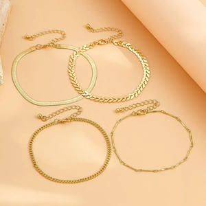 Set of four gold punk anklets featuring snake, fishbone, and twisted chain designs with clasps