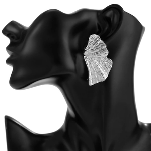 Dettaglio dell'orecchino a foglia di ginkgo argento con texture martellata su modella