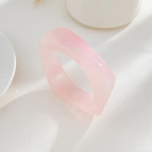 Macro shot of minimalist translucent pink resin chunky bangle with geometric wide edges