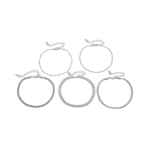Detail view of 5-piece silver anklet set featuring snake chain and heart charms