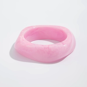 Close-up of pink marble pattern resin bracelet with irregular thick geometric design