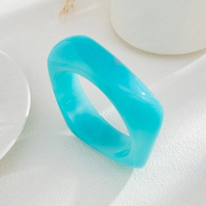 Detail of blue translucent acrylic ring with irregular geometric marble texture