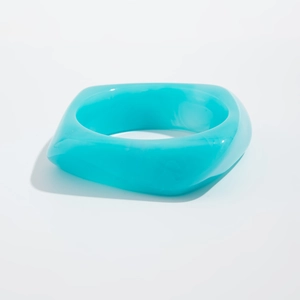 Macro shot of bright blue translucent acrylic bangle with geometric square outer frame