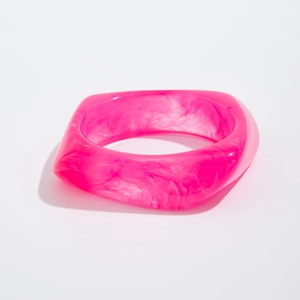 Macro detail of chunky magenta acrylic resin bracelet with unique marble textures