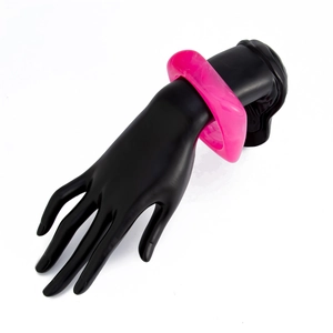 Detail shot of chunky pink marble acrylic bracelet on a black hand display model
