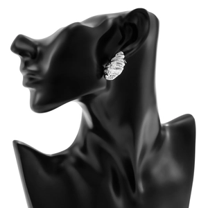 Macro detail of large silver punk style teardrop earring with fine horizontal texture on model