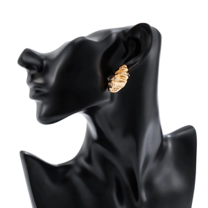 Detail showing gold drop earrings with textured waves worn on a black model silhouette