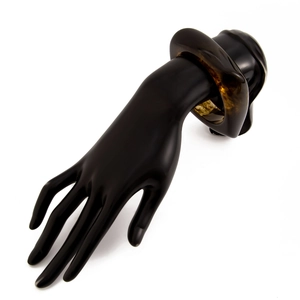 Detailed view of bold chunky tortoise shell resin bangle on black hand model
