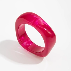 Detailed view of chunky translucent rose red acrylic bracelet with marble texture
