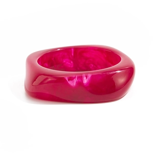 Detailed macro view of the thick fuchsia acrylic bangle with artistic marble swirl patterns