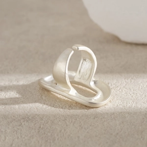 Macro shot of silver matte irregular floral ring with a minimalist brushed metal finish