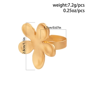 Macro shot of gold petal ring showing matte brushed texture and floral design details