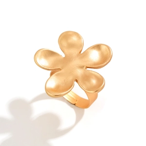 Detailed macro view of matte gold flower ring with five petals and adjustable band