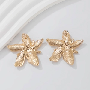 Detailed view of gold flower stud earrings with a 5-petal design and textured metal finish