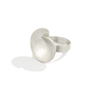 Close-up of matte silver irregular wrinkled disk open ring in minimalist geometric design