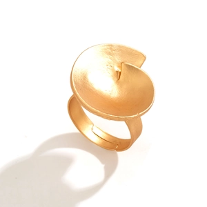 Detail view of golden spiral ring with matte texture and adjustable open band design