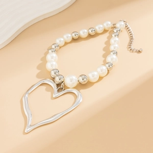 Minimalist pearl and silver bead necklace featuring a large irregular lava heart pendant
