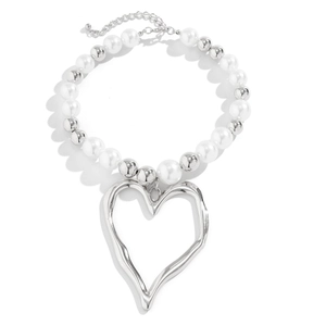 Detail of irregular molten heart pendant with mixed faux pearls and silver beads necklace
